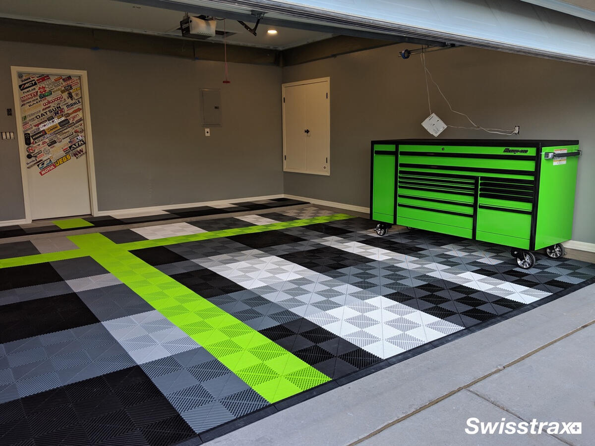 Green, black and gray Swisstrax garage floor with matching tool cabinet.