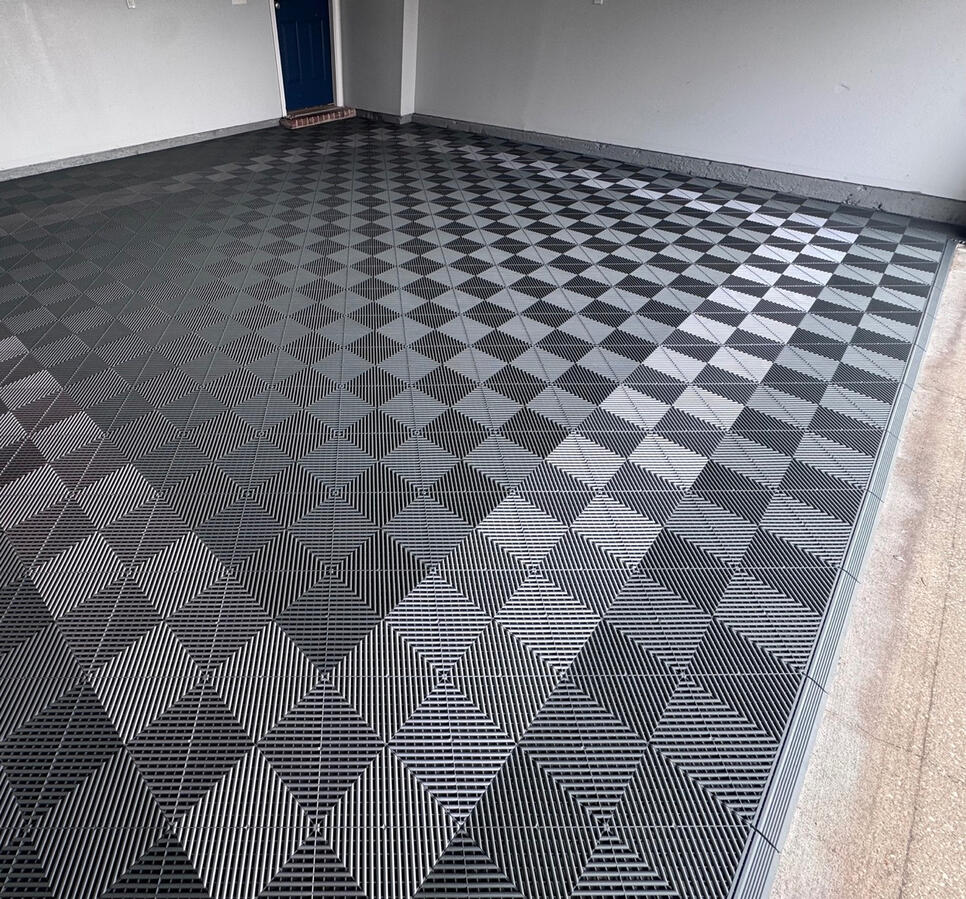 Completed slate gray Swisstrax garage floor at garage entrance Completed slate gray Swisstrax garage floor at garage entrance