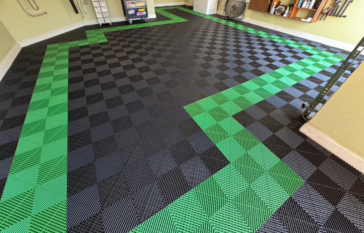 Gray car parked on a blue, black, and gray Swisstrax garage floor
